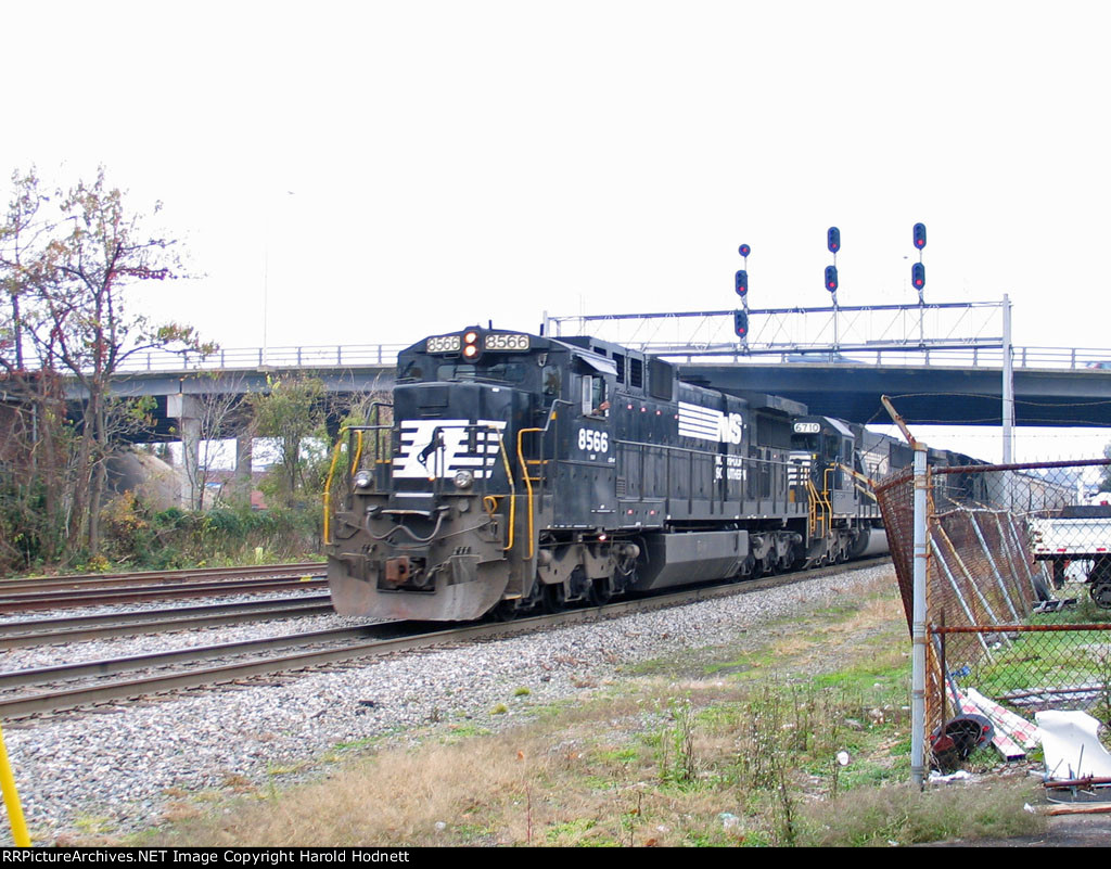 NS 8566 leads a northbound train past the signals at Elm